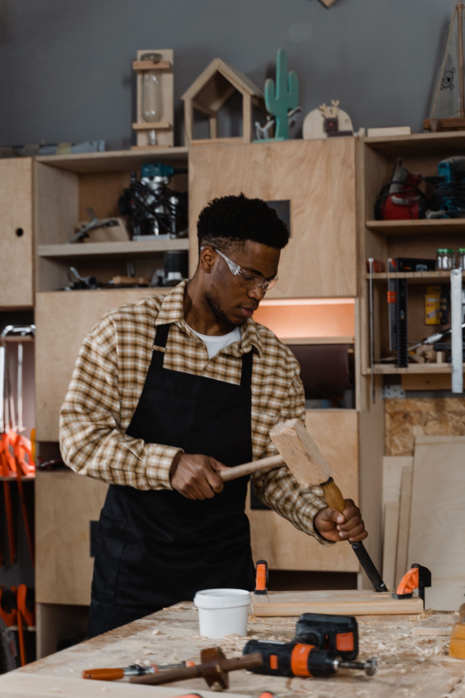 An Ominya joiner shaping a piece at the workshop bench